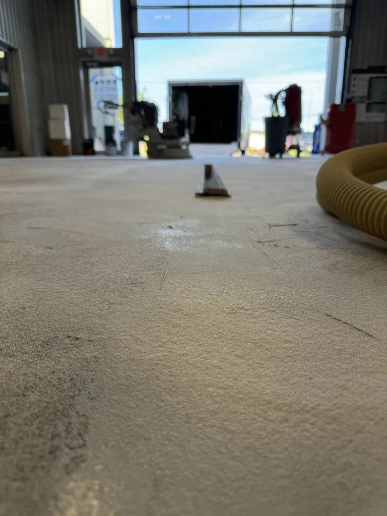 Damaged concrete floor in a commercial facility awaiting repair and resurfacing by Stateline Surface Solutions
