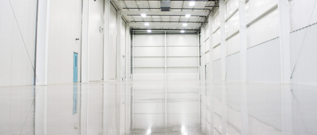 Reflection of a beautiful concrete floor in an airport hangar warehouse like space showing an excellent polish