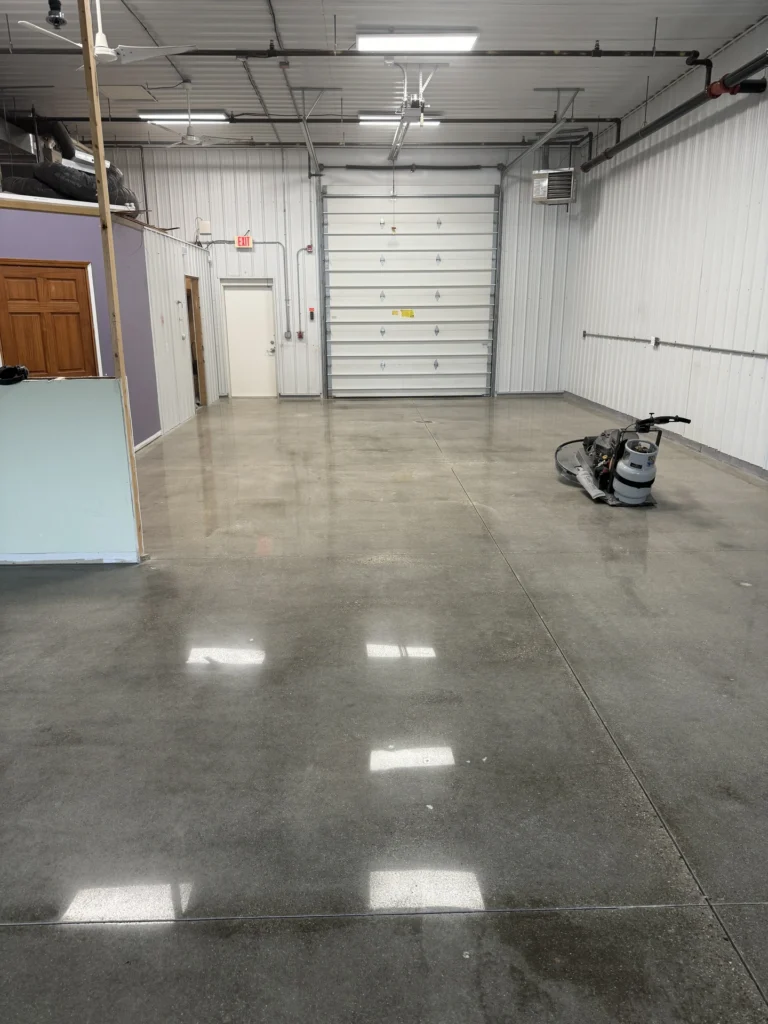 Polished concrete floor in a garage interior with storage areas and equipment